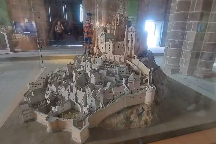Scale model of Mont Saint-Michel abbey and village inside museum, stop on small-group day trip by luxury van