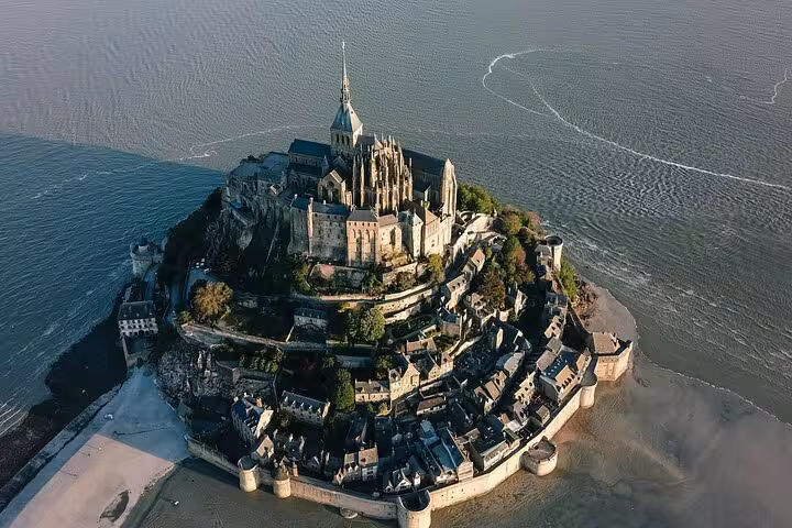 Aerial view of Mont-Saint-Michel island abbey surrounded by tidal waters in Normandy, France