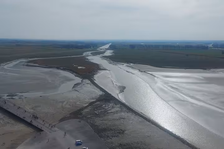 Aerial view of Mont Saint Michel bay and tidal flats, scenic highlight on small group luxury van day trip