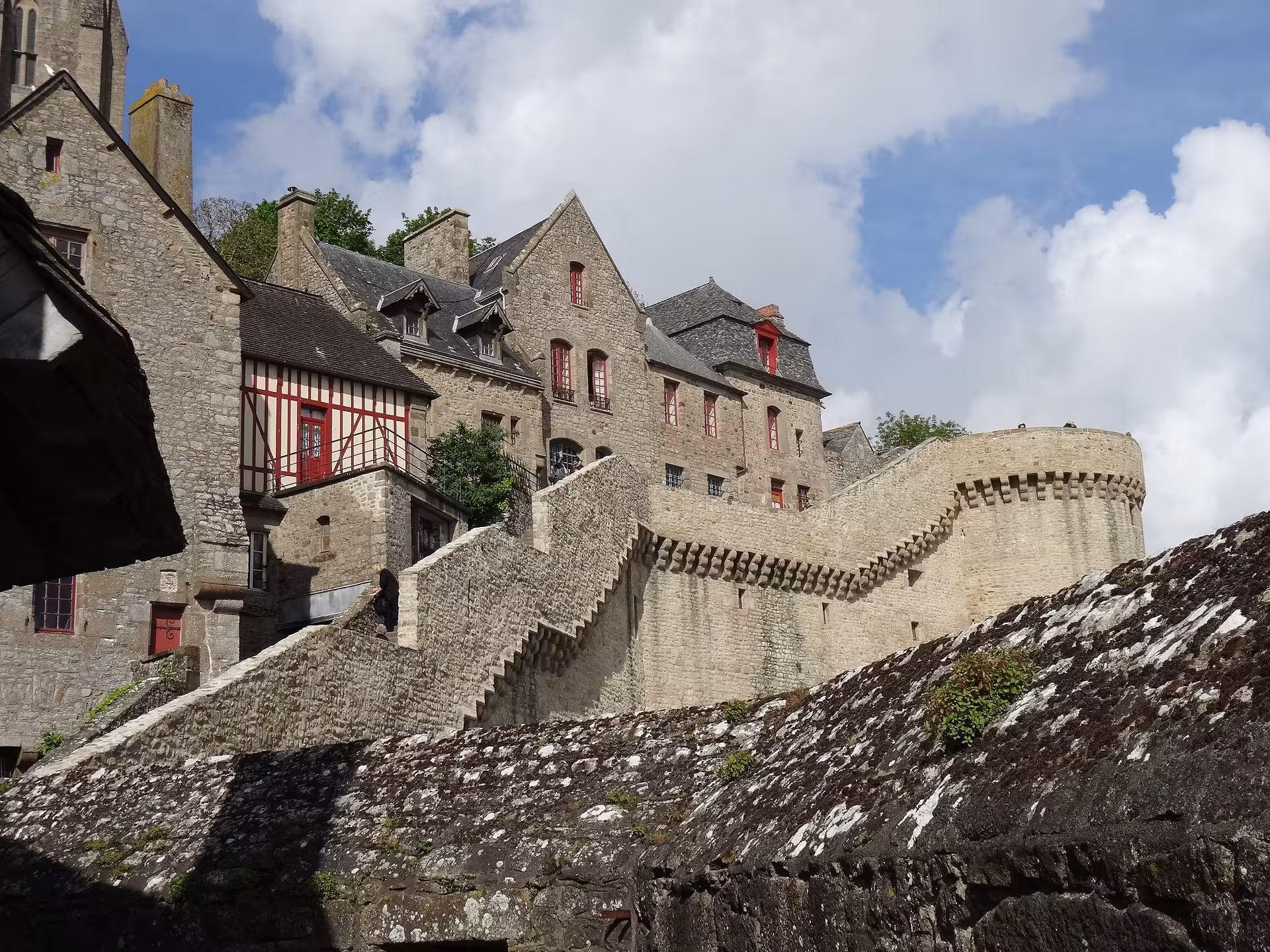 Stone ramparts and village houses at Mont Saint-Michel, featured stop on private luxury van VIP tour
