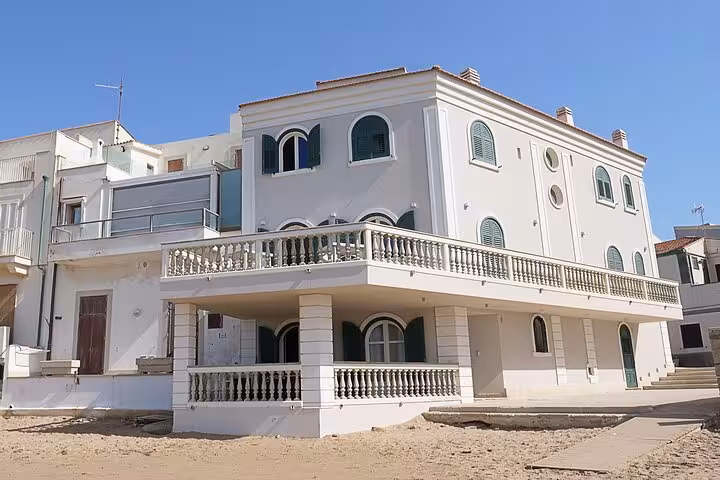 Elegant seaside villa featured in Il Commissario Montalbano, showcasing classic Sicilian architecture in Punta Secca.