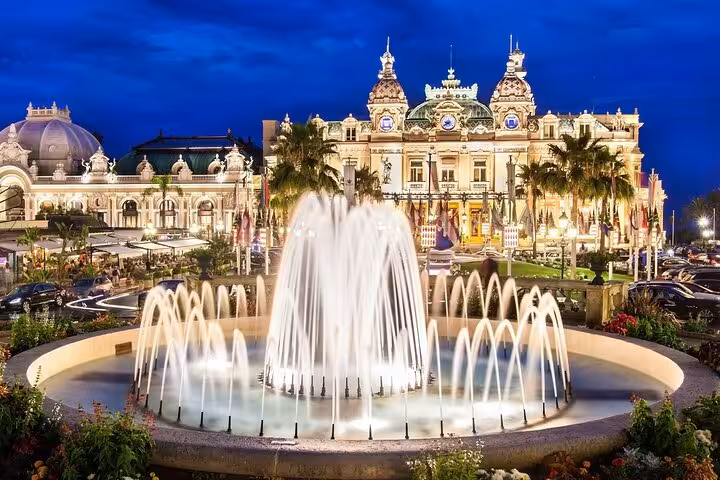 Illuminated Monte Carlo Casino fountain at dusk, French Riviera Monaco
