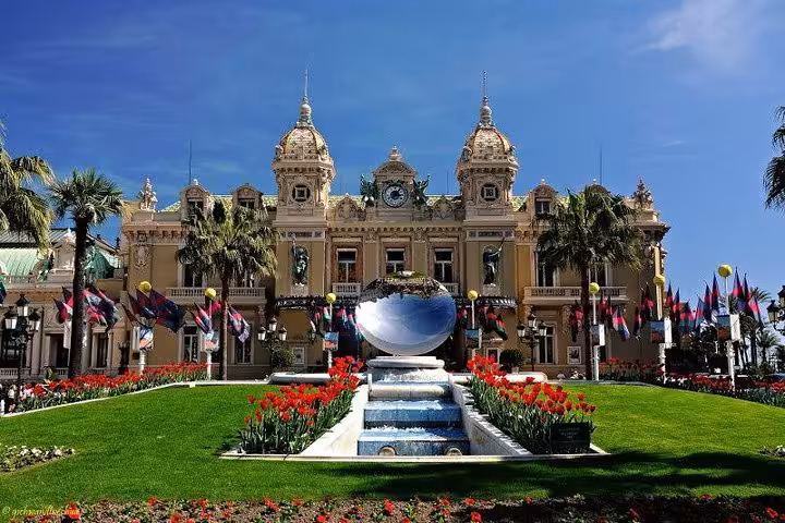 Grand Casino Monte Carlo facade with red tulips fountain and ornate Beaux-Arts architecture in Monaco