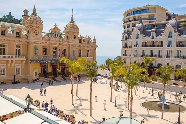 Elegant Monte Carlo Casino and palm-lined square in Monaco, featured in the French Riviera tour from Nice.