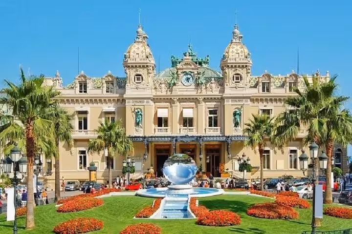 Monte Carlo Casino in Monaco with palm gardens, a highlight on a private day trip from Nice via Eze