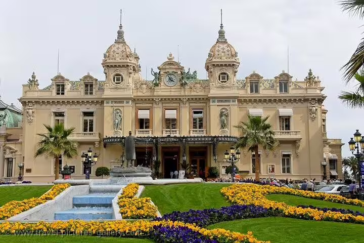 Monte Carlo Casino grand facade with ornate Beaux-Arts architecture, fountain and colorful flower gardens, Monaco