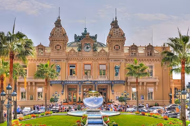 Monte Carlo Casino in Monaco with palm gardens, visited on a private driver sightseeing tour from Cannes and Nice