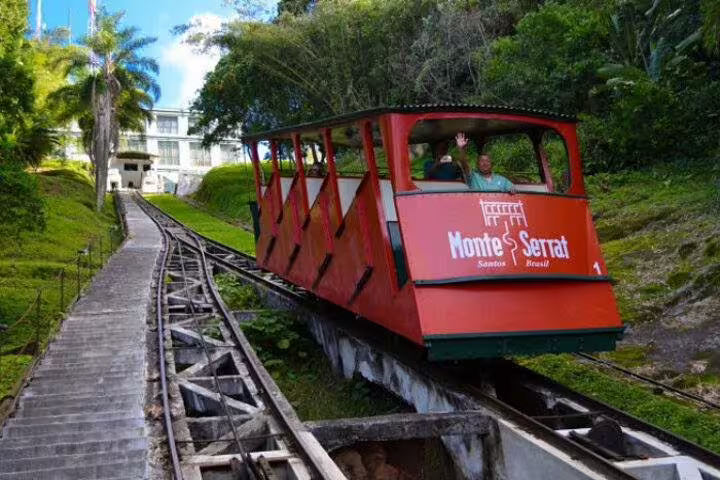 Monte Serrat funicular in Santos, Brazil, ascending through tropical greenery, offering panoramic views of the city.