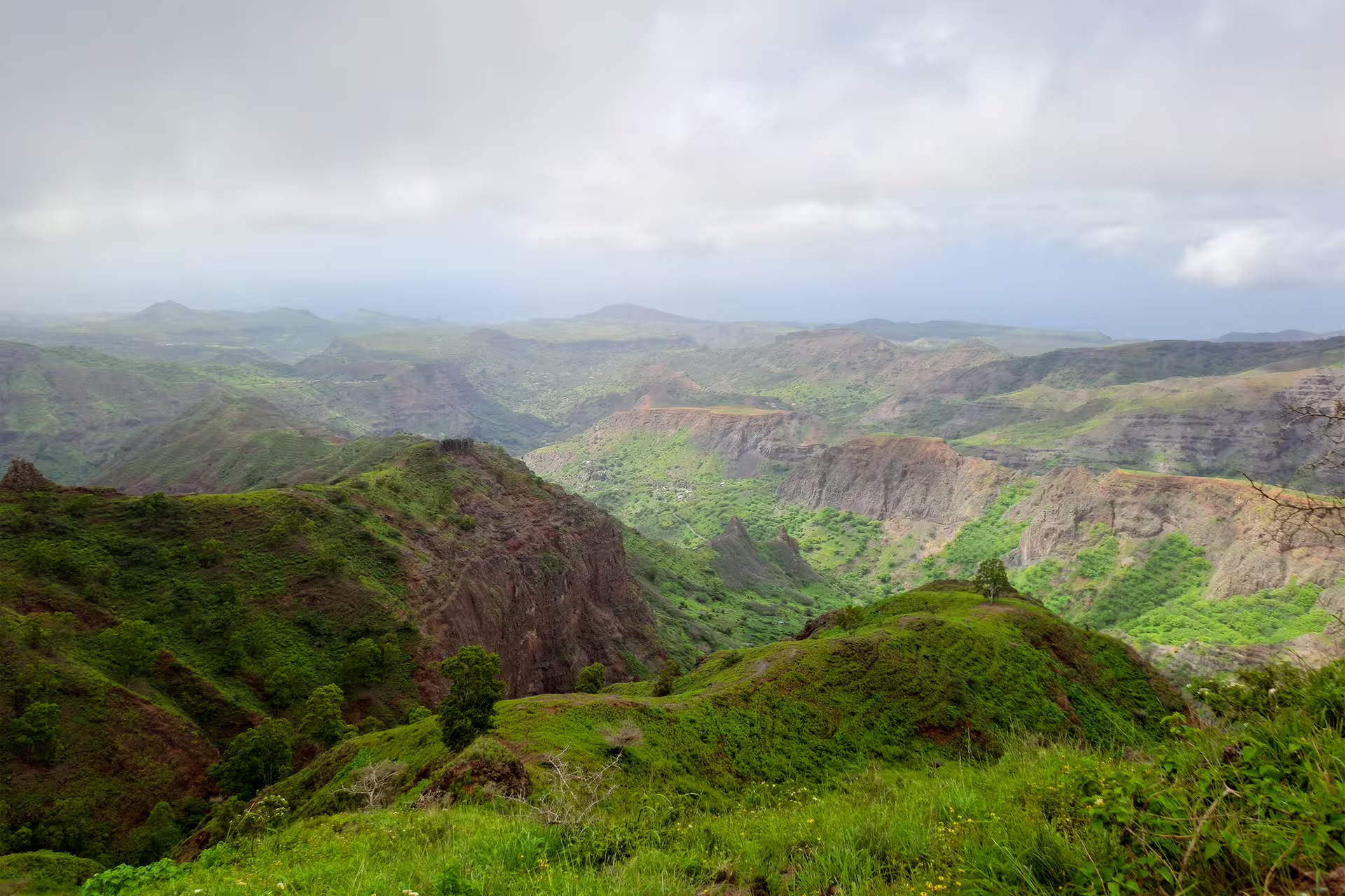 Scenic view of Monte Tchota Natural Park's verdant peaks and valleys, showcasing the lush landscape of Pico D'Antónia.