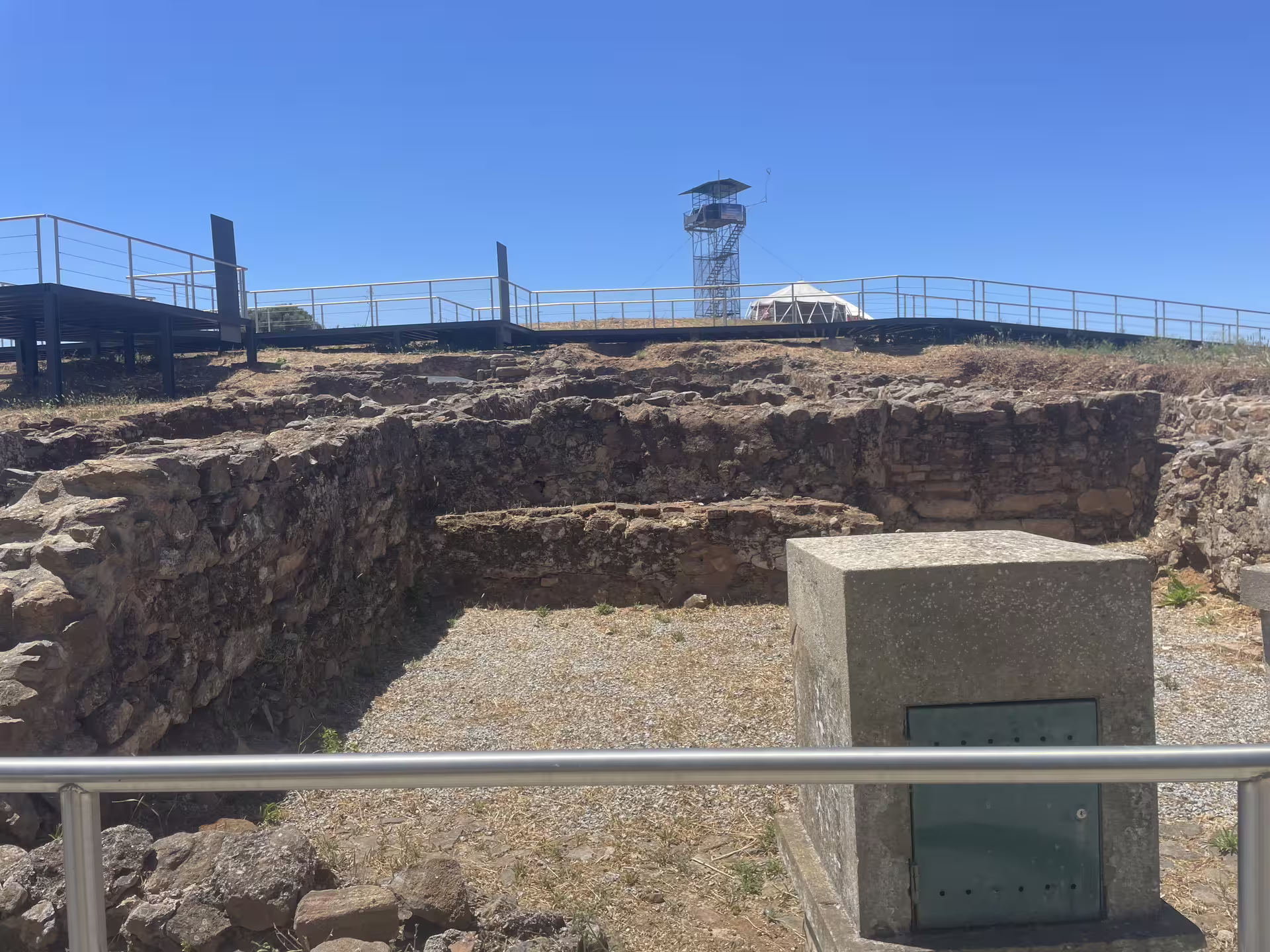 Historic stone ruins and a modern observation deck at Montemor-o-Novo Castle, Portugal.