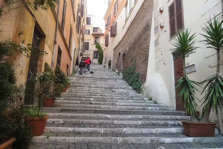 Charming cobblestone stairway in Rome's Monti District neighborhood explored during a street food walking tour