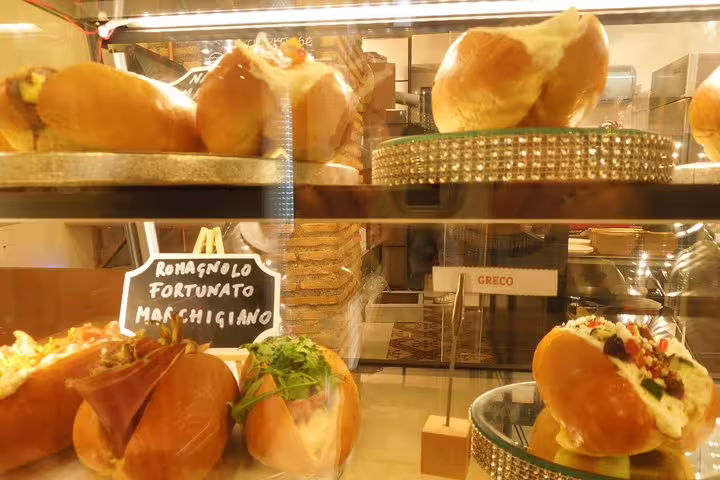 Traditional Roman street food sandwiches on display at a local deli during Monti district food tour Rome