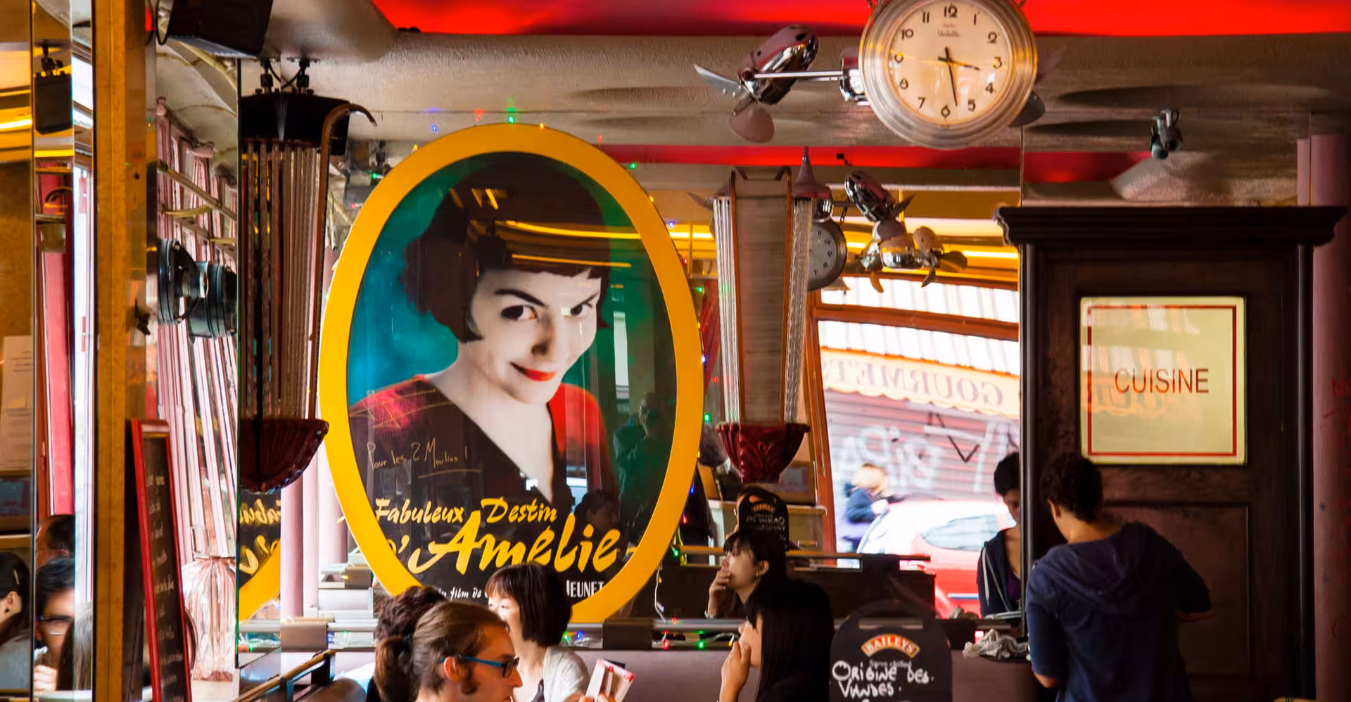 Cozy Montmartre café interior with Amélie poster, capturing the essence of the Montmartre Food and Wine Tour.