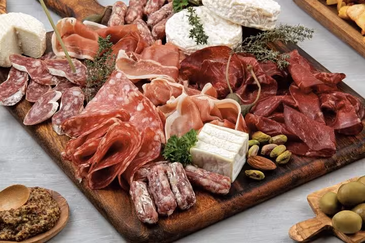 French charcuterie and cheese board dinner included on semi-private Montmartre tour with Paris cabaret show