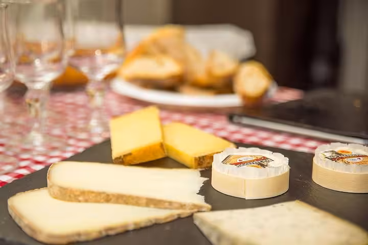 A selection of gourmet French cheeses displayed on a slate board, perfect for savoring during the Montmartre food tour.