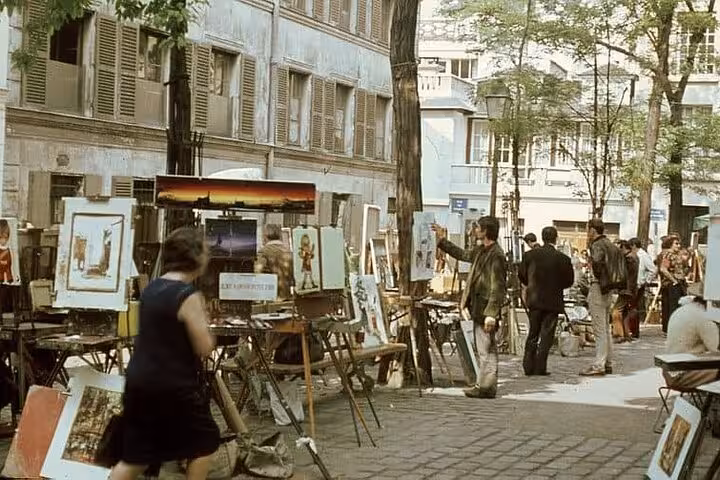 Artists displaying paintings at an outdoor art market on the streets of Montmartre, Paris