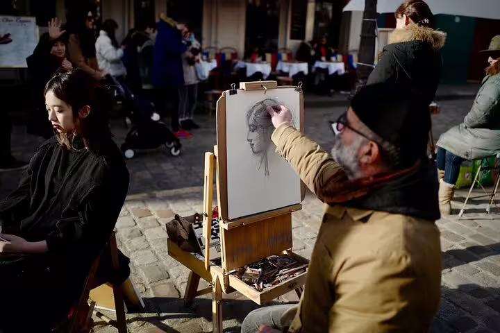 Street artist sketching portrait of young woman on easel in Montmartre square, Paris