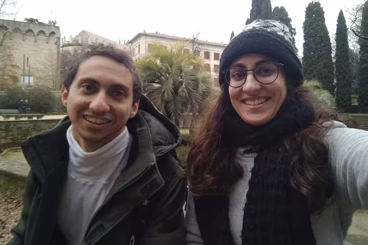 Two smiling tourists on a self-guided walking tour in Montpellier on a winter day