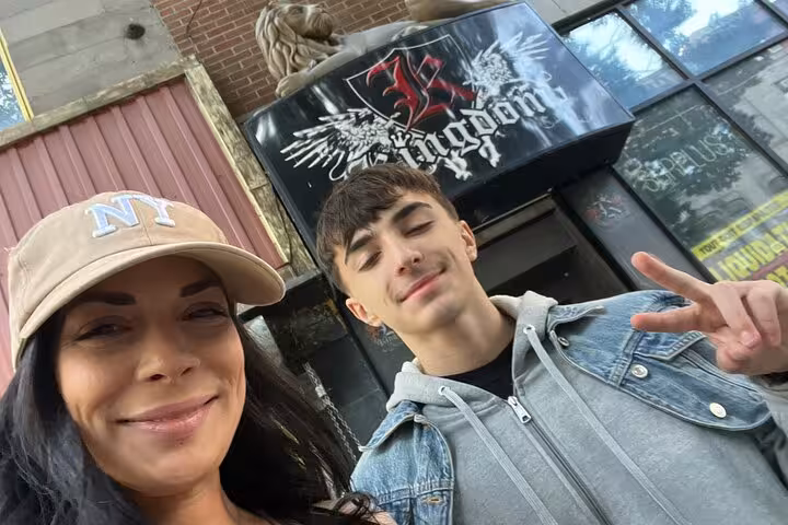 Two people smiling in selfie outside Kingdom venue in Montreal during prohibition mystery walking tour