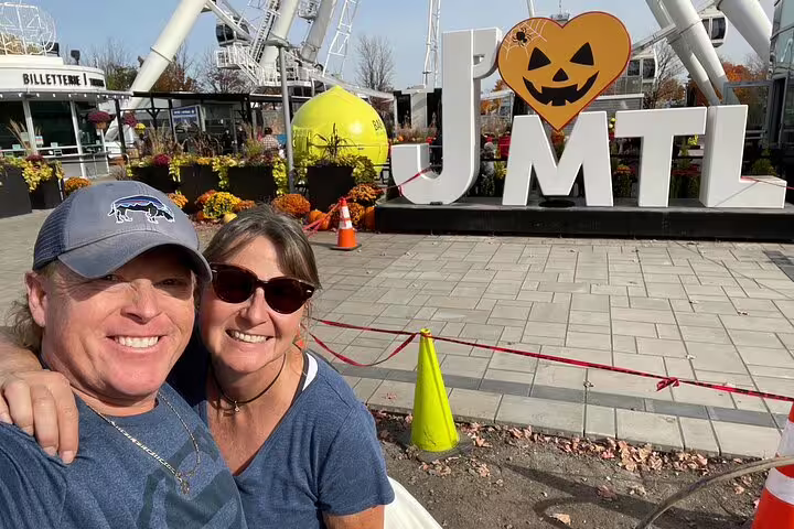 Couple selfie at the Old Port I Love MTL sign near La Grande Roue on a Montreal scavenger hunt walking tour