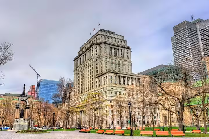 Historic Sun Life Building viewed from Dominion Square park in downtown Montreal on a cloudy day
