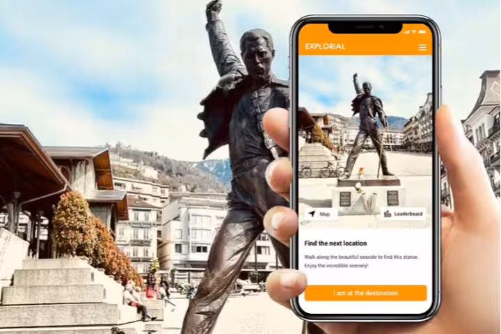 Phone app guiding to Freddie Mercury statue in Montreux, Switzerland, for a self-guided scavenger hunt walking tour