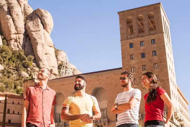 Group of friends enjoying a sunny day at Montserrat, highlighting the vibrant culture and scenic views of the area.