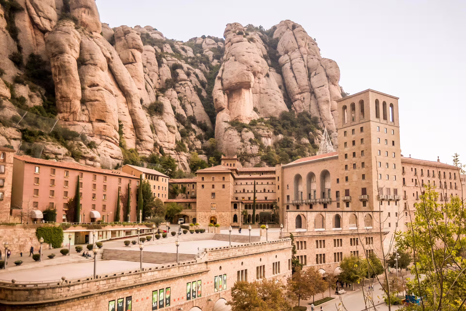 Montserrat Monastery nestled against dramatic jagged rock formations on a Barcelona day trip with wine tasting.