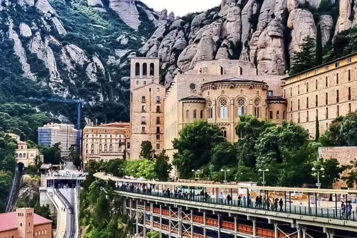 Stunning Montserrat monastery nestled in rugged mountains, showcasing historic architecture on a private tour.