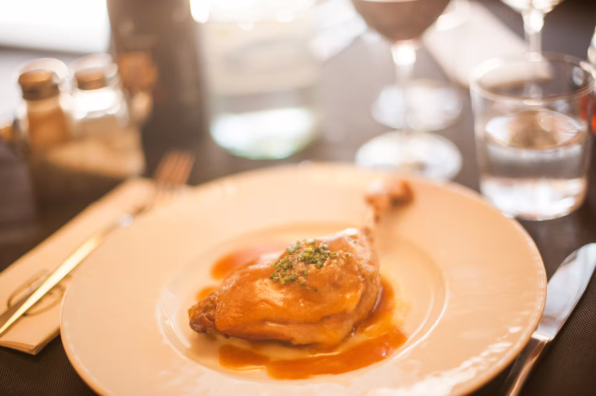 Succulent roasted chicken with herbs, elegantly plated for Montserrat gastronomy experience.