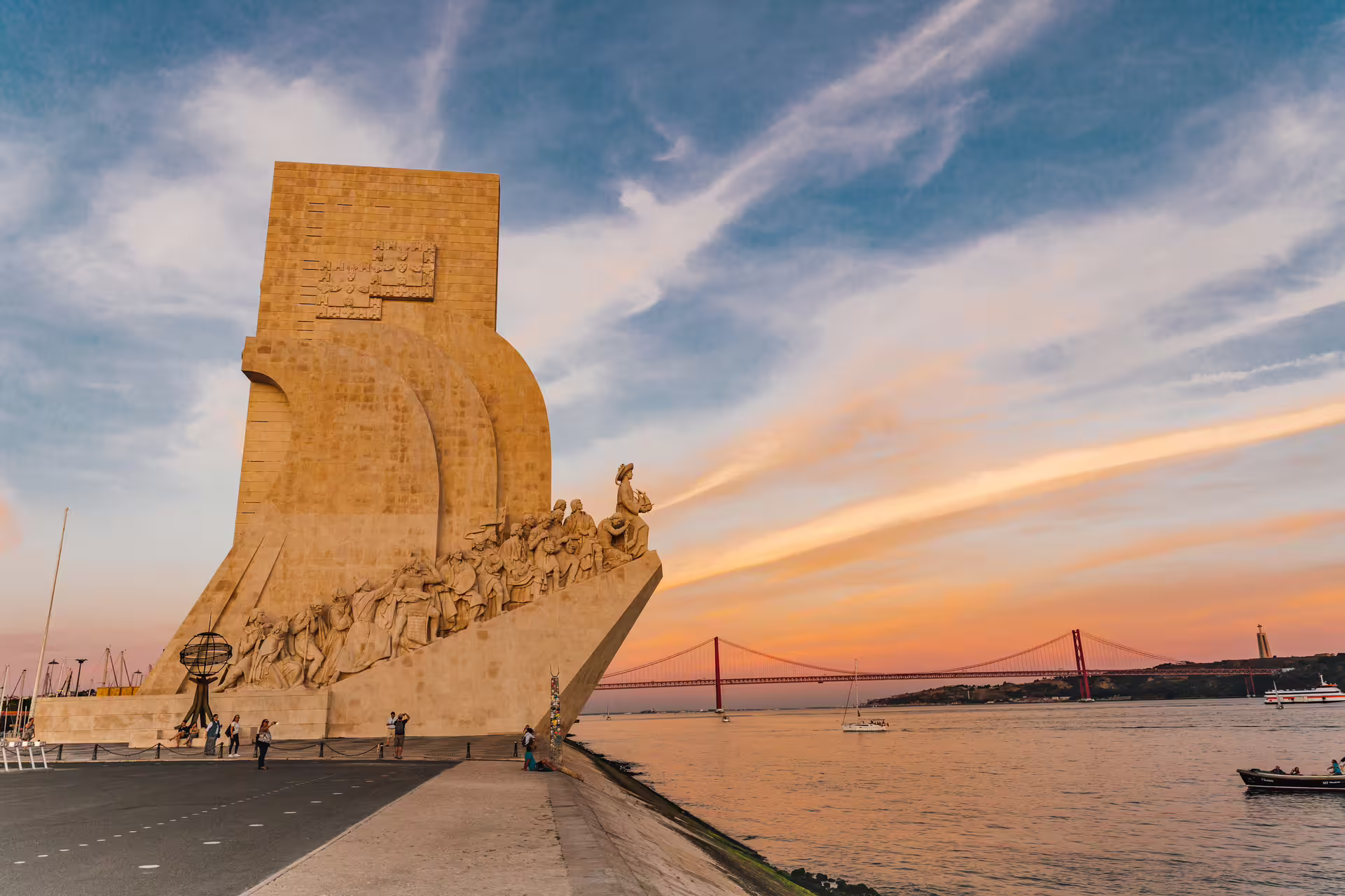 Monument of Discoveries at sunset by the Tagus River, capturing Lisbon's exploration heritage on a Tuktuk tour.