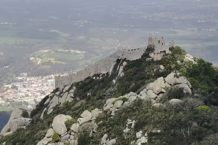 Majestic Moorish Castle in Sintra, Portugal, overlooking scenic landscapes, featured in a private tour from Lisbon with monument tickets.