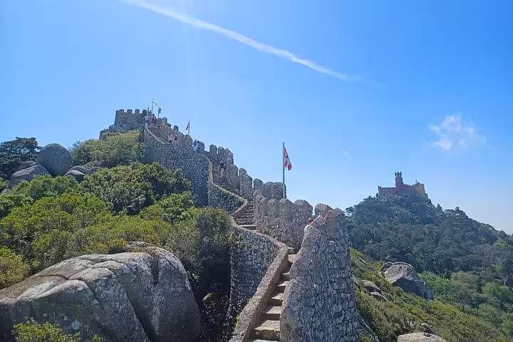 Moorish Castle stone wall stairway in Sintra hills, scenic stop on tuk tuk tour to Cascais coast