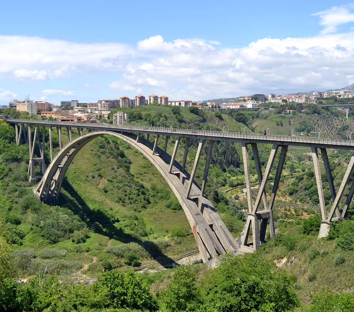Panoramic view of the Morandi Bridge in Cosenza arching over a lush green valley on the Legendary Calabria Tour route