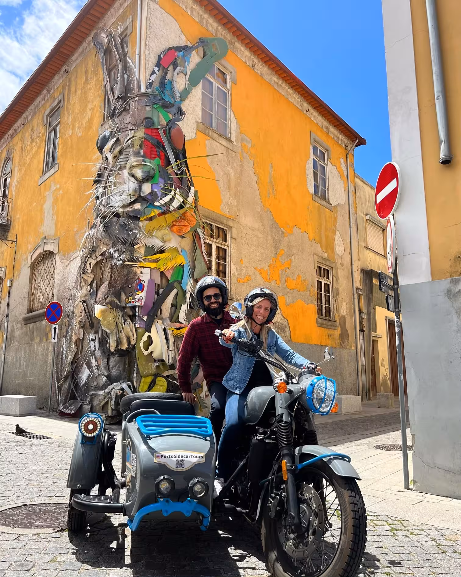 Guests on a vintage sidecar motorbike beside Porto street art mural, guided MORNING TOUR PORTO experience