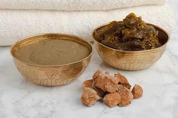 Authentic Moroccan hammam scrub ingredients including ghassoul clay black soap and himalayan salt with white towel