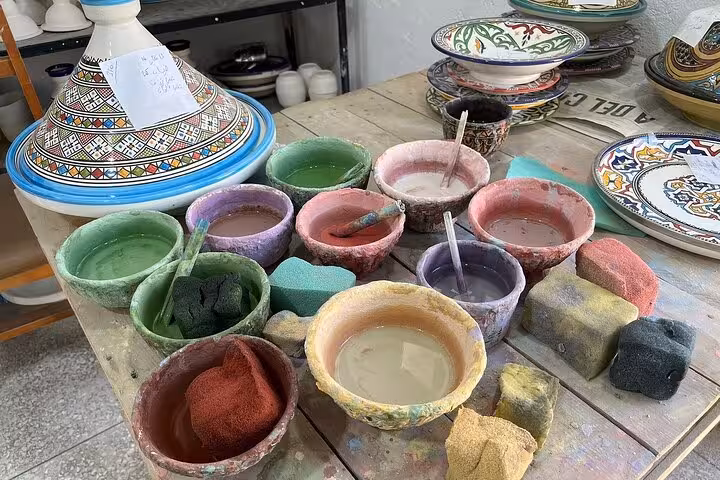 Colorful ceramic paints and traditional Moroccan pottery on display in an artisan workshop in Old Medina Fez.