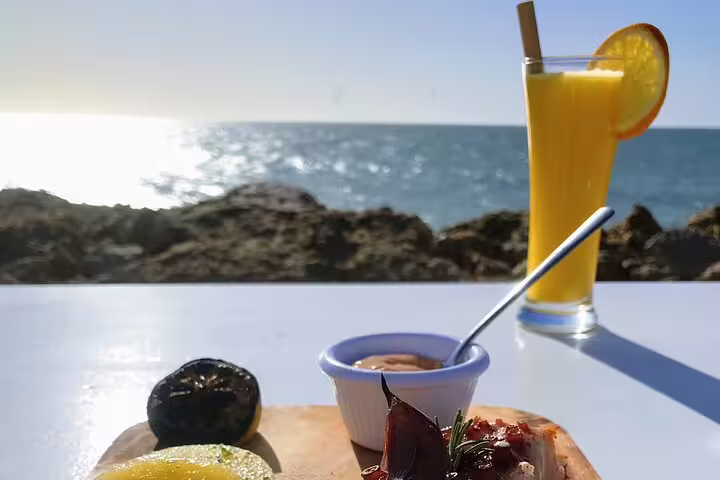 Moroccan seaside breakfast and fresh orange juice on Atlantic coast stop from Marrakech 3-day ocean tour