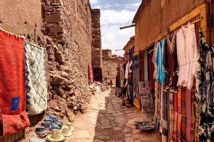 Traditional souk alley with Berber rugs and textiles in Morocco, on Anti-Atlas & Sahara tour from Marrakech