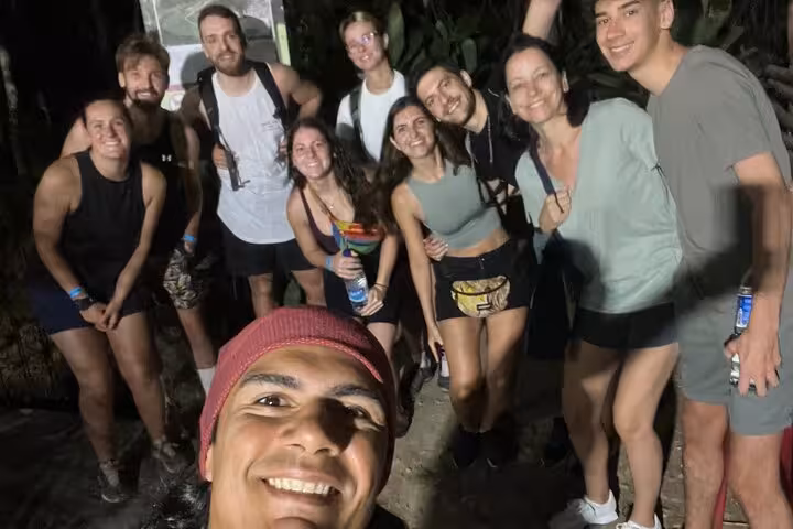 Group of hikers enjoying a night trek on the Two Brothers trail in Rio, capturing the thrill of adventure.
