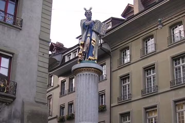 Colorful Moses fountain statue on ornate column in historic Bern city square, Switzerland