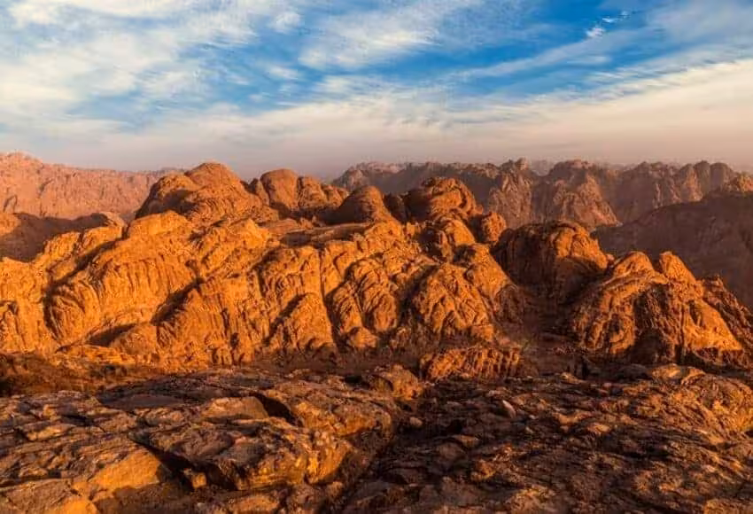 Golden sunrise over Mount Sinai peaks, scenic viewpoint on Moses Mountain hike and St. Katharine tour