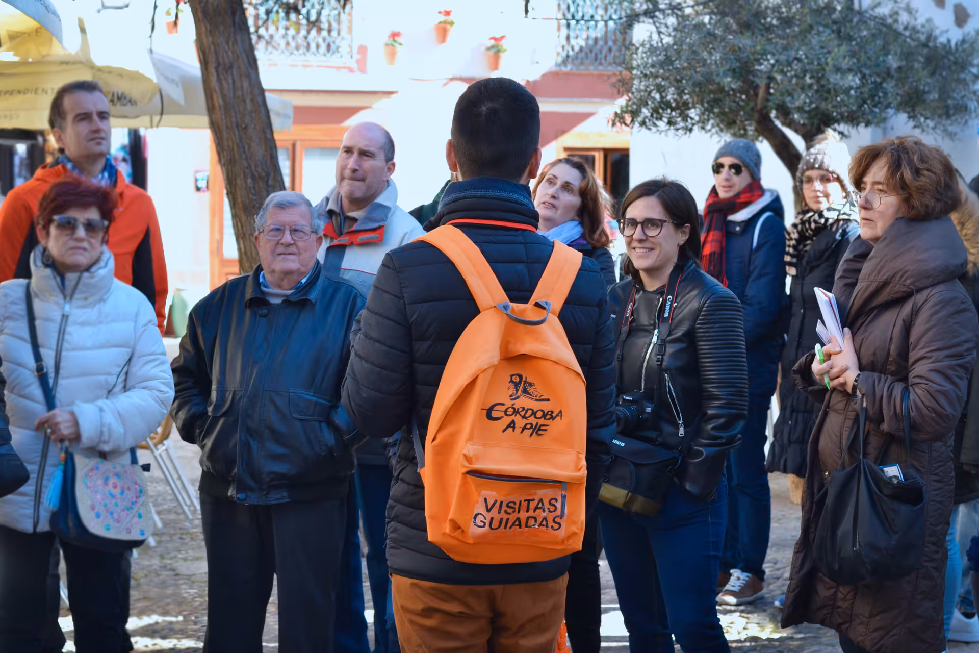 A guided tour group explores the historic Mosque-Cathedral of Córdoba, led by an experienced local guide.
