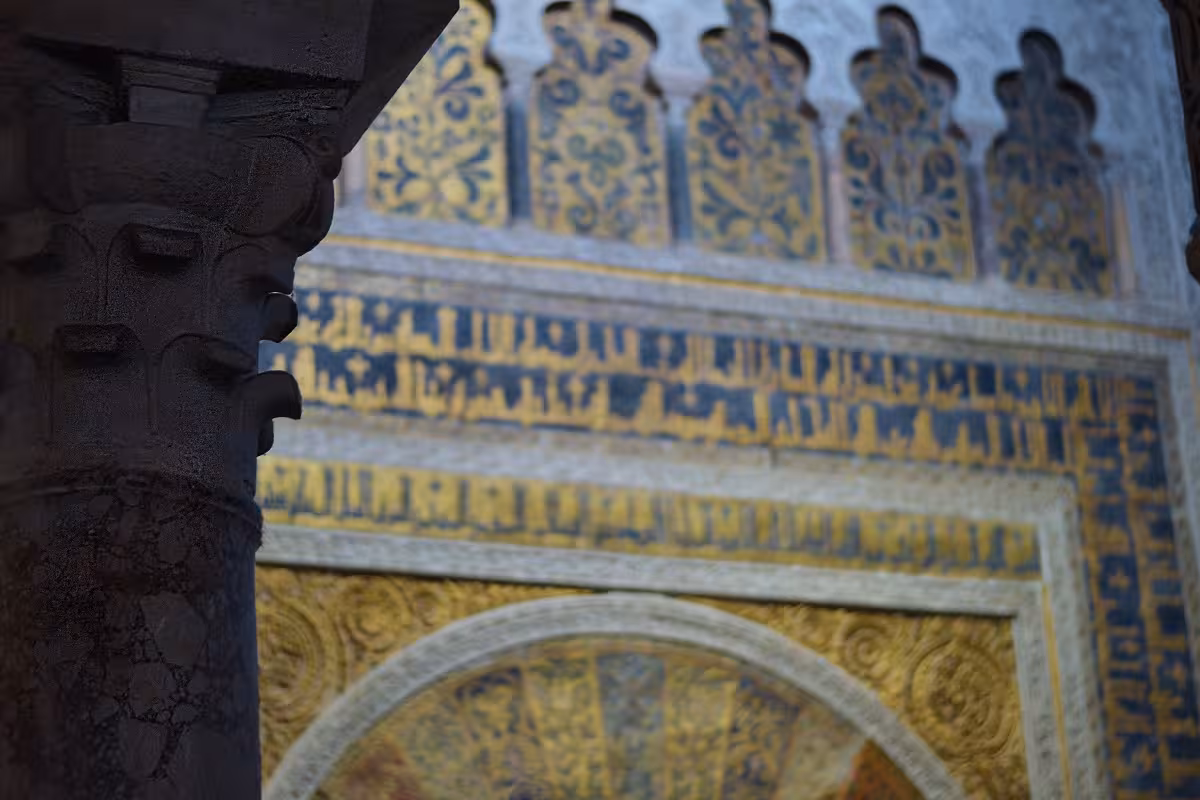 Intricate Islamic geometric patterns and calligraphy on a Mosque Cathedral wall, highlighting Moorish architecture.