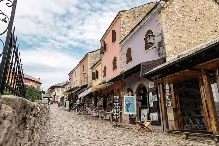 Cobblestone street in Mostar Old Town with colorful Ottoman-era shops, a stop on the Mostar tour