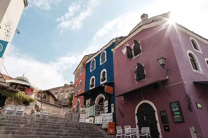 Colorful historic buildings by the steps in Mostar Old Town, Bosnia, on Mostar and Kravice Waterfalls tour