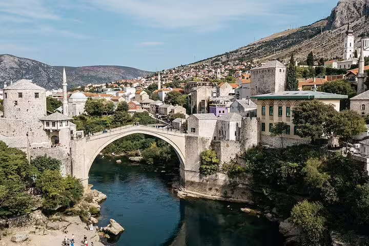 Panoramic view of Mostar Stari Most and Neretva River, key landmark on scheduled Kravice waterfalls tour