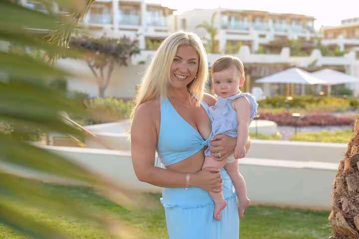 Mother and child smiling in a garden setting at Analipsi, perfect for a memorable private photoshoot.