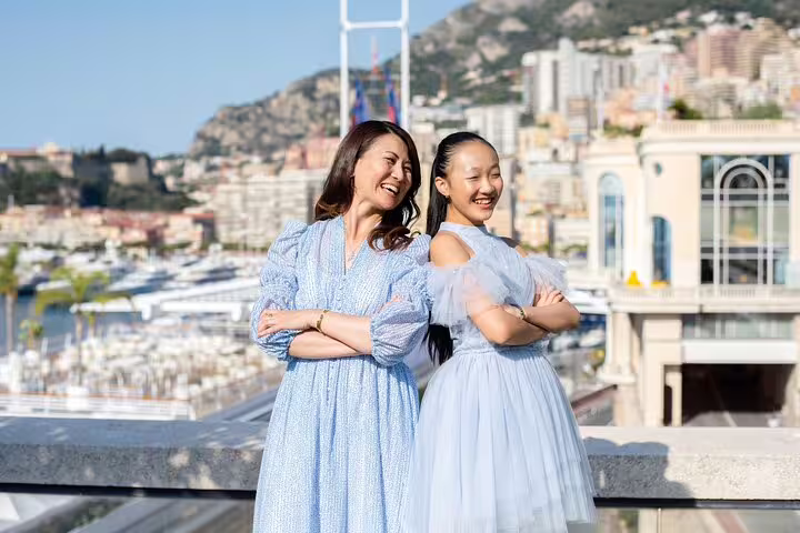 Mother and daughter smiling with Monte Carlo marina views during a private Monaco personal travel photographer tour