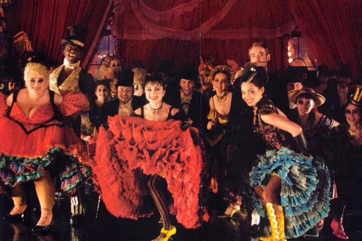 Colorful can-can dancers performing on stage at the Moulin Rouge cabaret in Paris